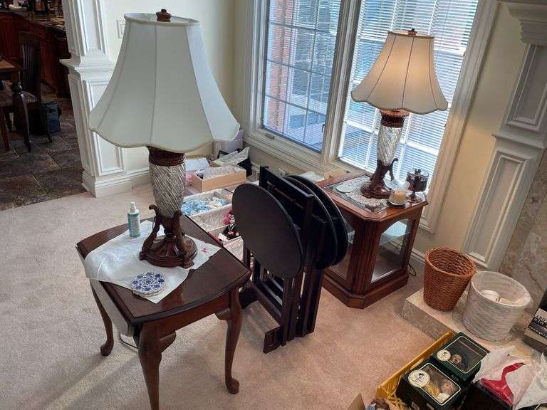 Living room. Two matching lamps with two side tables (one is a glass curio side table) and TV trays on stand. One TV tray is missing. Nice lot of furniture.