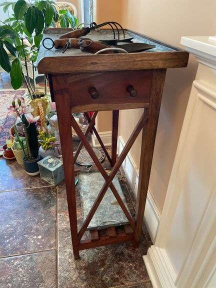 Sunroom. Gardener side table with galvanized top,  with decor tools. Approximately 3 feet tall.