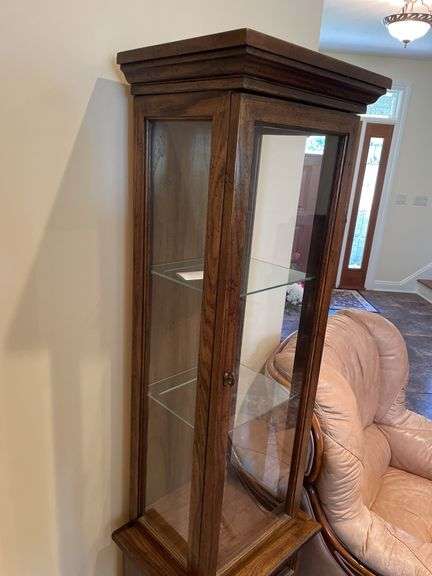 Entryway. Curio cabinet with light. 69 inches tall 19 inches wide.