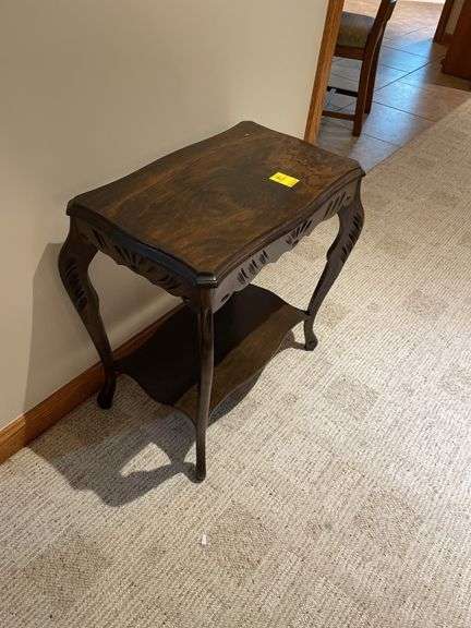 Basement. Small side table with unique carved  design. Approximately 24 inches tall.