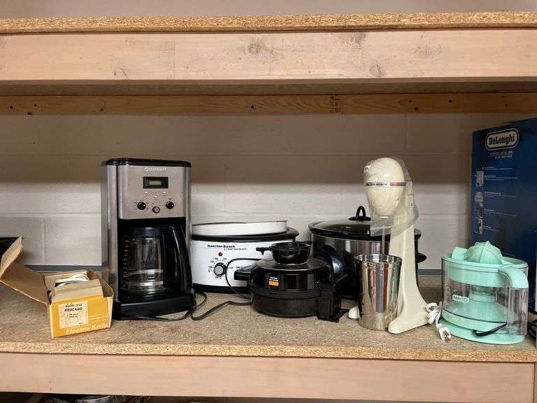 Appliance lot includes coffee maker, crockpots, waffle maker, mixer, electric knife.