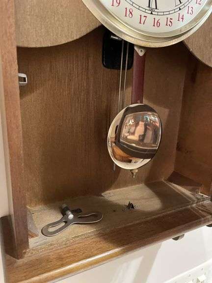 Basement. 31 day regulator clock. Approximately 24 inches tall. Includes key.