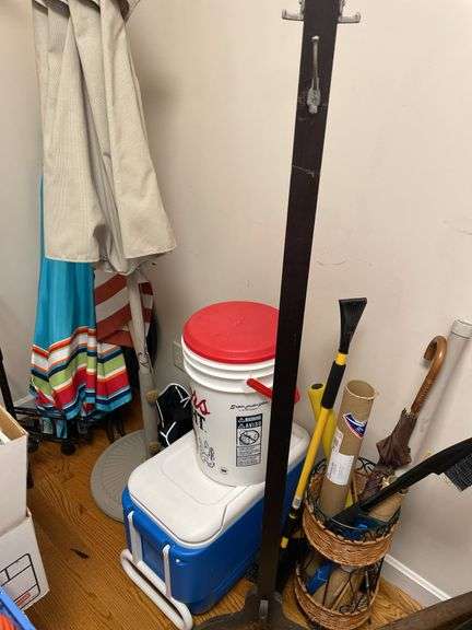 corner lot includes umbrellas, coolers, coat, rack, umbrella, stand, and miscellaneous.