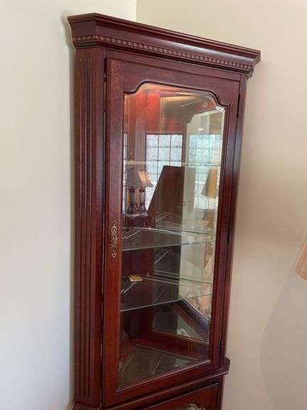 Living room. Corner curio cabinet with standing lamp. Curio is 78 inches tall by approximately 27 inches wide.