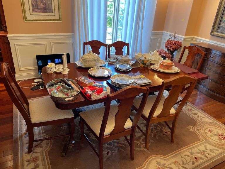 Dining room. Dining room table with leaf and cover. Includes six matching chairs. Only One captains chair.. Not including contents. Chairs may be different maker than table.
