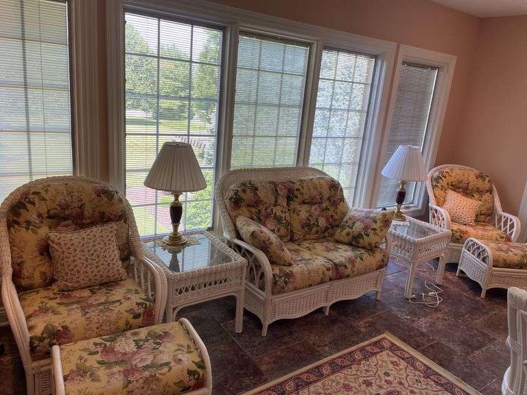 Sunroom. Lot of quality wicker furniture. Including loveseat. Two side chairs with Ottomans. Glass top wicker side tables. Includes floral cushions in good shape. With two matching lamps.