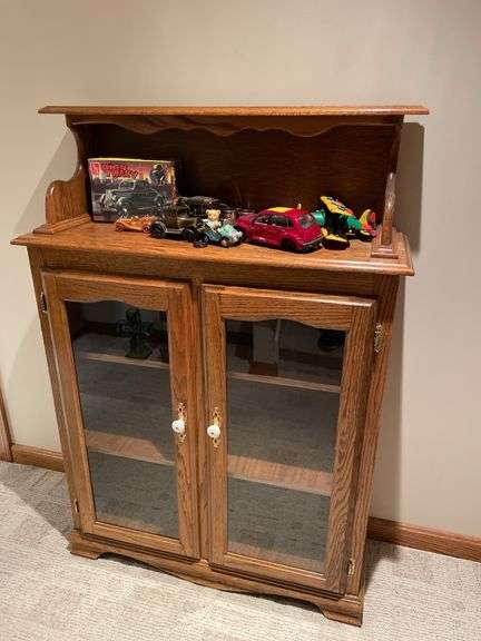 Basement. Cabinet with glass front shelves, approximately 58 inches tall and 37 inches wide.