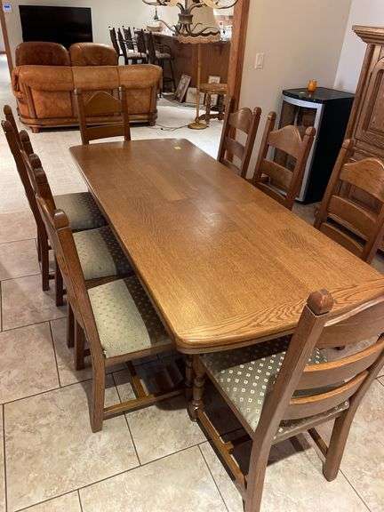 Country dining set in Oak, 34 x 83 pedestal table with eight ladder back chairs. Chairs are very solid and this is a nice quality set. Also includes Oak side cabinet with drawers. Easy loadout through walkout basement.