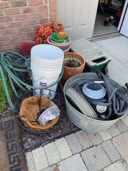Gardeners lot includes small planters, wagon, terra-cotta, and plastic planters, hoses, galvanized bucket.