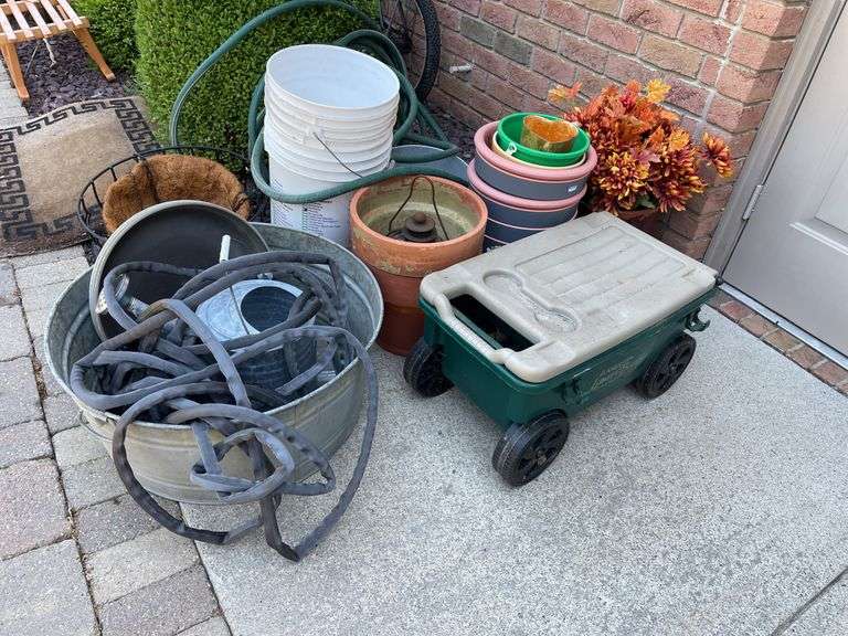 Gardeners lot includes small planters, wagon, terra-cotta, and plastic planters, hoses, galvanized bucket.