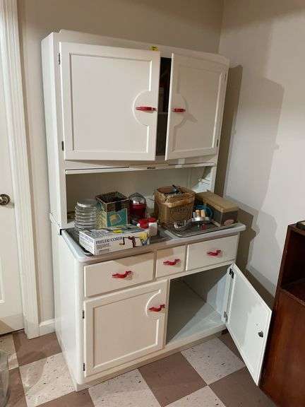 Basement. Vintage kitchen Hosier cabinet.  Painted White with red handles. Approximately 71 inches tall by 39 inches wide. Nice piece.