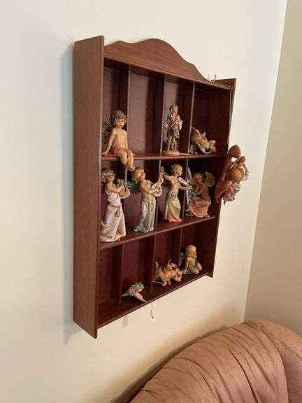 Den. Hanging curio shelf with collection of Daniella Angels.
