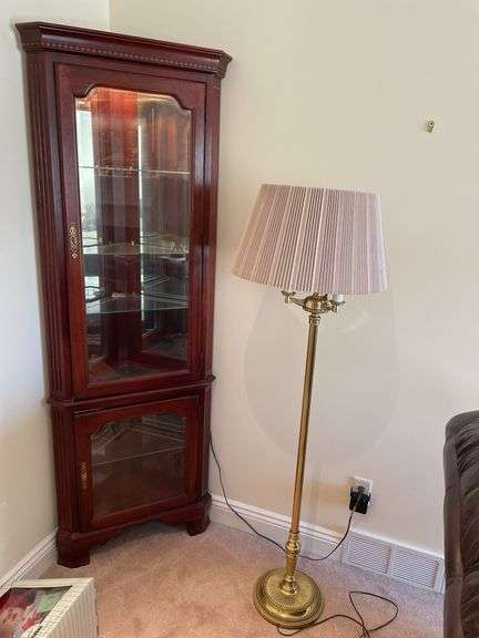 Living room. Corner curio cabinet with standing lamp. Curio is 78 inches tall by approximately 27 inches wide.