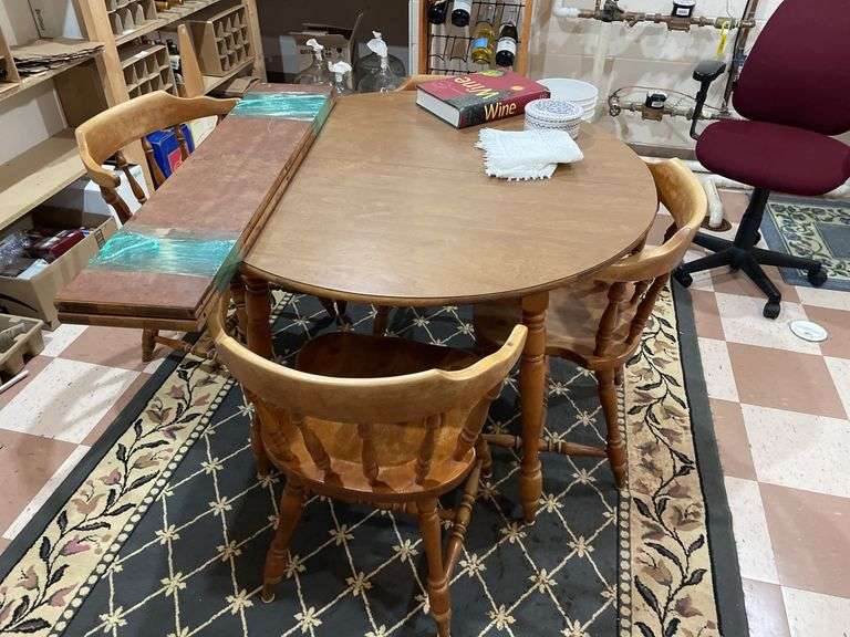 Basement. Round table with leaf and four matching chairs. Table is 42 inches across. Includes rug underneath.