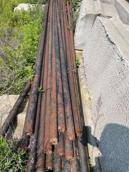 Lengths of heavy gauge pipe and approximately 30 foot long light pole/mast