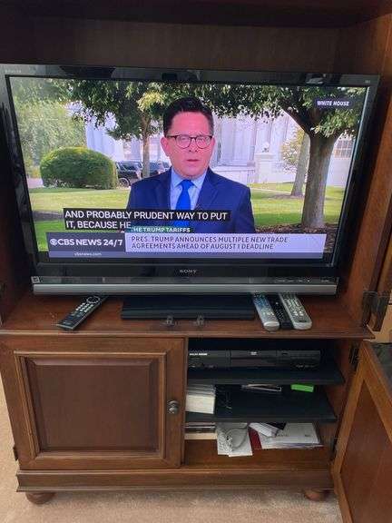 Living room. 40 inch Sony Bravia KDL – 40 XBR6 TV with remote powers on and is working includes Philips Magnavox DVD player.