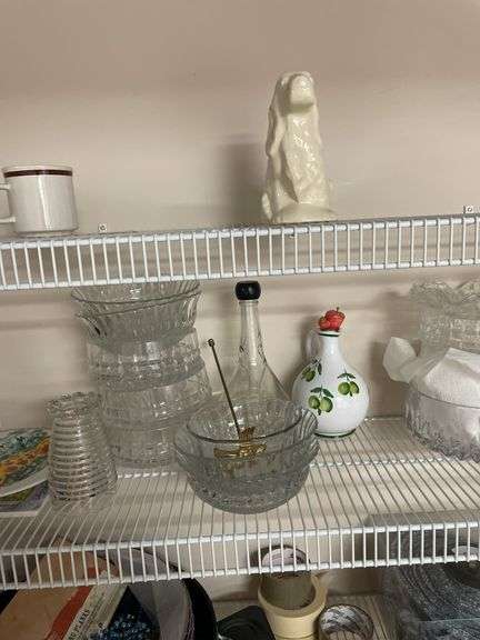 Contents of white shelves include some craft supplies, tins, miscellaneous.