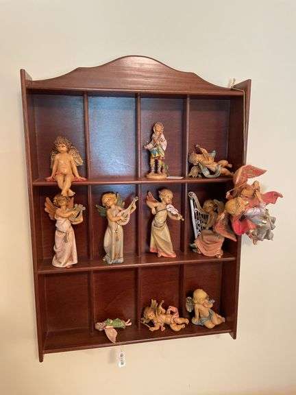Den. Hanging curio shelf with collection of Daniella Angels.