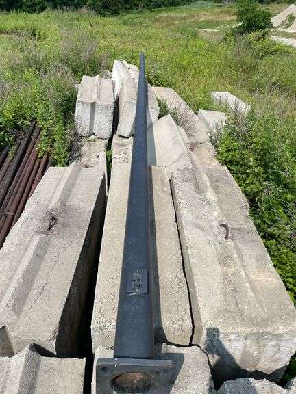 Lengths of heavy gauge pipe and approximately 30 foot long light pole/mast