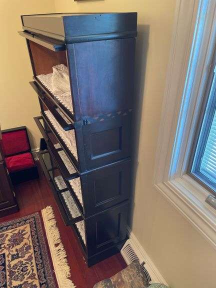 Den. Vintage barrister case with glass front drop-down doors. Approximately 57 inches tall and 34 inches wide.