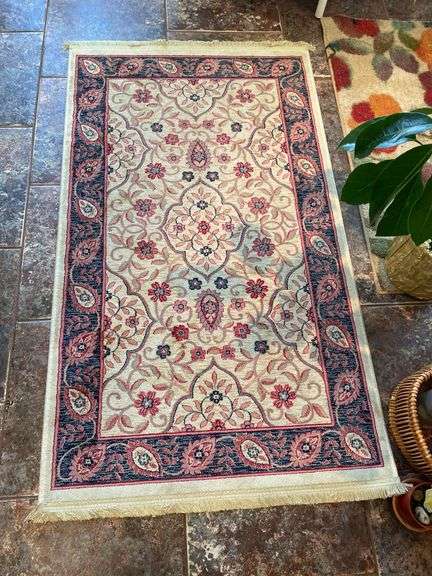 Sunroom. Two floral rugs. With decor and faux plant. Vases basket and faux plants.