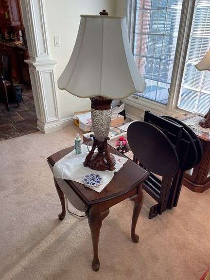 Living room. Two matching lamps with two side tables (one is a glass curio side table) and TV trays on stand. One TV tray is missing. Nice lot of furniture.