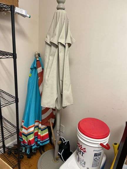 corner lot includes umbrellas, coolers, coat, rack, umbrella, stand, and miscellaneous.