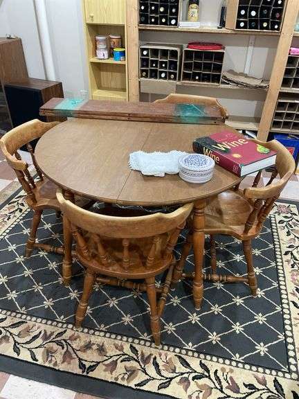 Basement. Round table with leaf and four matching chairs. Table is 42 inches across. Includes rug underneath.