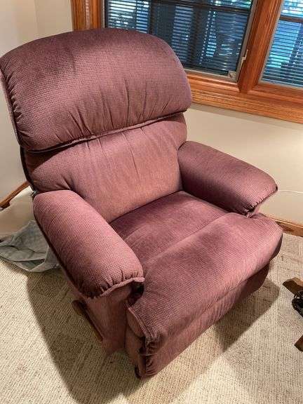 Basement. Recliner with round side table and ornate lamp.