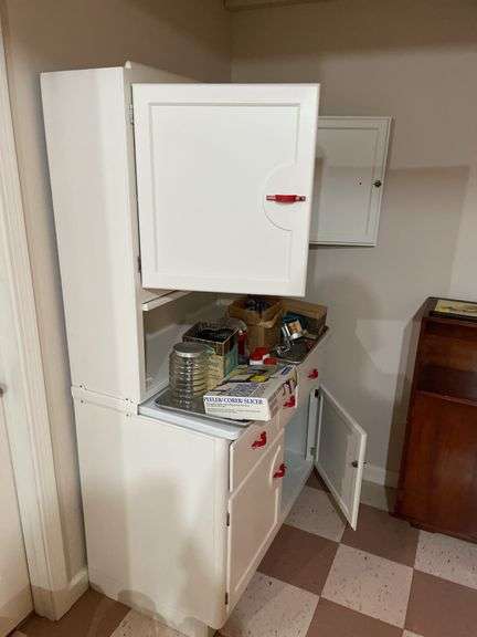 Basement. Vintage kitchen Hosier cabinet.  Painted White with red handles. Approximately 71 inches tall by 39 inches wide. Nice piece.