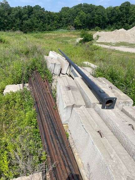 Lengths of heavy gauge pipe and approximately 30 foot long light pole/mast