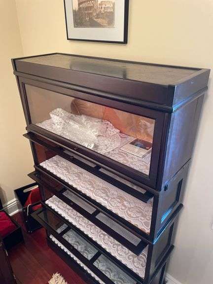 Den. Vintage barrister case with glass front drop-down doors. Approximately 57 inches tall and 34 inches wide.