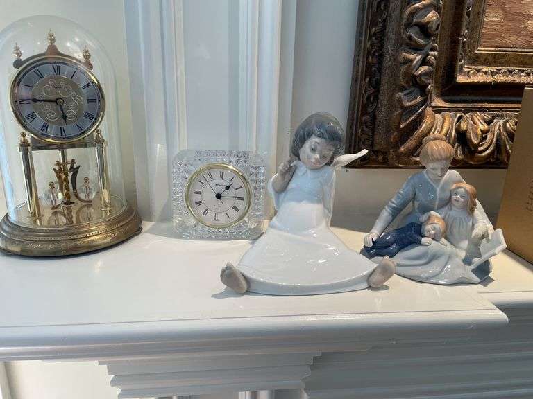 Living room. Lladro angel figurine. A mother’s touch figurine and two clocks.