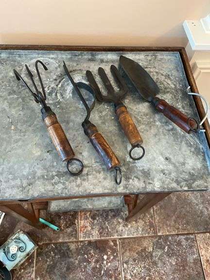 Sunroom. Gardener side table with galvanized top,  with decor tools. Approximately 3 feet tall.