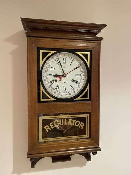 Basement. 31 day regulator clock. Approximately 24 inches tall. Includes key.