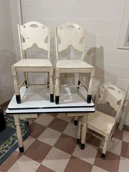 Basement. Enamel top vintage table with three matching wooden chairs. Table is 40 inches wide.