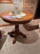 Basement. Recliner with round side table and ornate lamp.