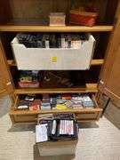 Basement. Contents of cabinet, which include VHS tapes with some well-known movies. Cassettes and CDs. Large assortment.