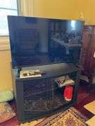 Den. 32 inch Toshiba fire TV with remote. And glass fronted entertainment stand. Powers on.