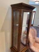 Entryway. Curio cabinet with light. 69 inches tall 19 inches wide.