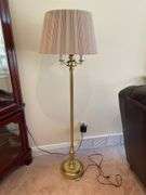 Living room. Corner curio cabinet with standing lamp. Curio is 78 inches tall by approximately 27 inches wide.