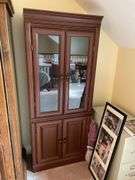 Glass fronted curio cabinet. Approximately 70 inches tall by 24 inches wide.