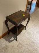 Basement. Small side table with unique carved  design. Approximately 24 inches tall.