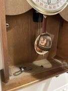 Basement. 31 day regulator clock. Approximately 24 inches tall. Includes key.