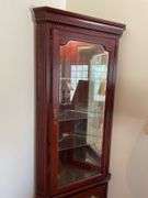 Living room. Corner curio cabinet with standing lamp. Curio is 78 inches tall by approximately 27 inches wide.