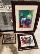 Basement. Large lot of framed wall art includes some prints photographs unique scenes. Nice variety review pictures for all pieces.