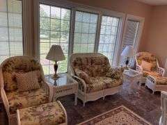 Sunroom. Lot of quality wicker furniture. Including loveseat. Two side chairs with Ottomans. Glass top wicker side tables. Includes floral cushions in good shape. With two matching lamps.