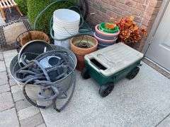 Gardeners lot includes small planters, wagon, terra-cotta, and plastic planters, hoses, galvanized bucket.