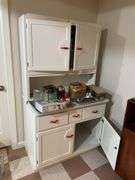 Basement. Vintage kitchen Hosier cabinet.  Painted White with red handles. Approximately 71 inches tall by 39 inches wide. Nice piece.