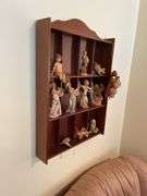 Den. Hanging curio shelf with collection of Daniella Angels.